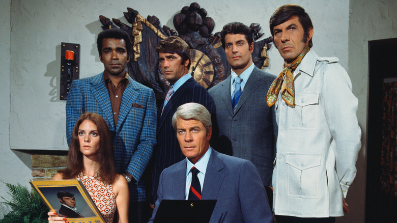 The Mission Impossible Cast standing together in formal attire