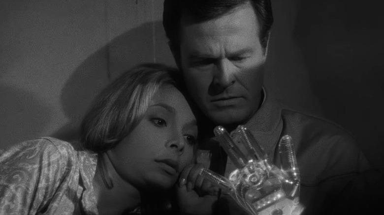Consuelo Biros (Arlene Martel) and Trent (Robert Culp) stare grimly at a glass hand in The Outer Limits (1963)