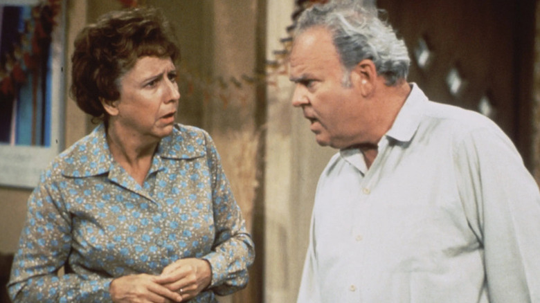 A concerned Edith Bunker (Jean Stapleton) looks at an annoyed Archie Bunker (Carroll O'Connor) in All in the Family