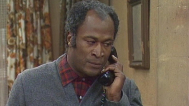 James Evans (John Amos) answers a phone in Good Times