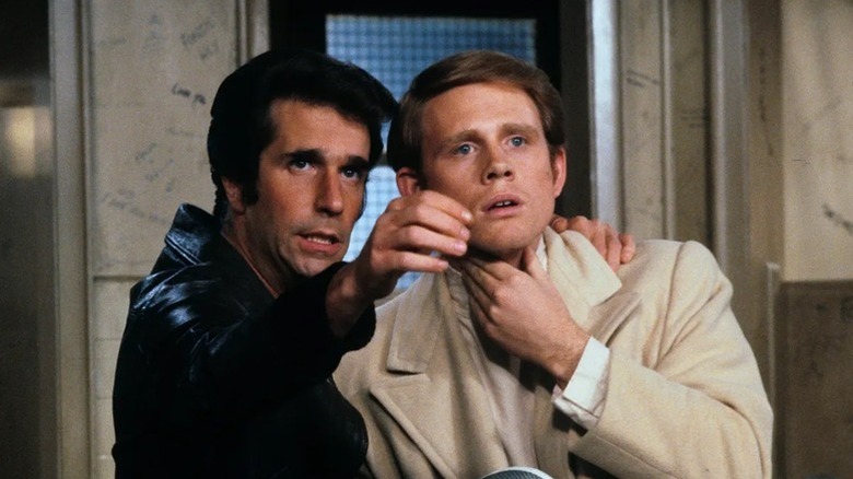 Arthur "Fonzie" Fonzarelli (Henry Winkler) puts his hand on Richie Cunningham's (Ron Howard) shoulder in Happy Days