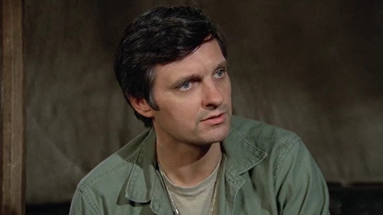 Benjamin "Hawkeye" Pierce (Alan Alda) looks thoughtfully in M*A*S*H