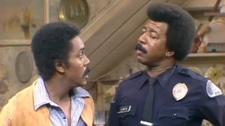 Lionel Sanford (Demond Wilson) looks incredulously at Officer Smitty (Hal Williams) in Sanford and Son