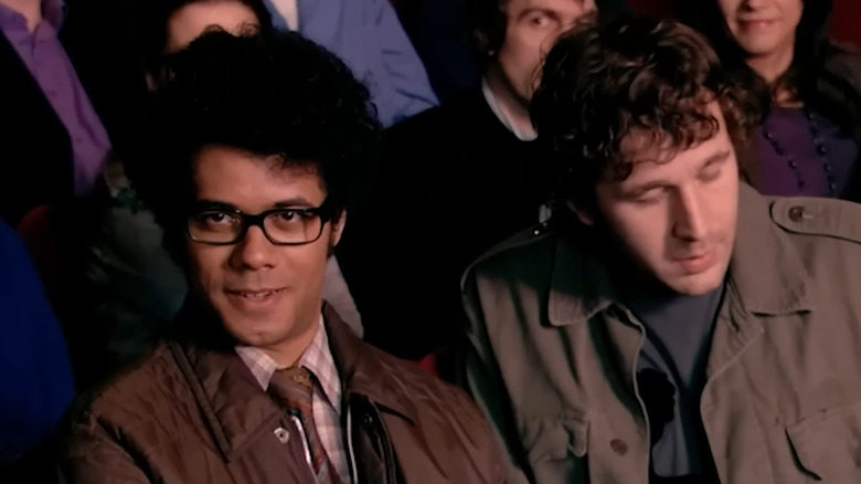 Richard Ayoade and Chris O'Dowd as Maurice Moss and Roy Trenneman, sitting together in a theater on The IT Crowd