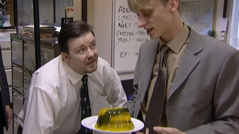 Ricky Gervais and Mackenzie Crook as David Brent and Gareth Keenan, examining a plate of jello with a stapler inside on The Office