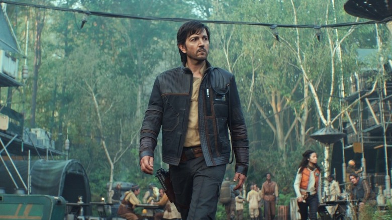 Cassian Andor (Diego Luna) walks through a rebel encampment on Andor