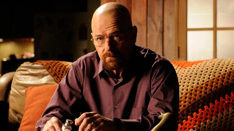 Walter White (Bryan Cranston) looks up while seated on a couch on Breaking Bad