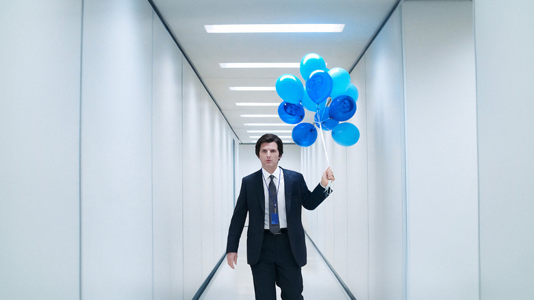 Mark Scout (Adam Scott) walks down a white hallway carrying blue balloons on Severance