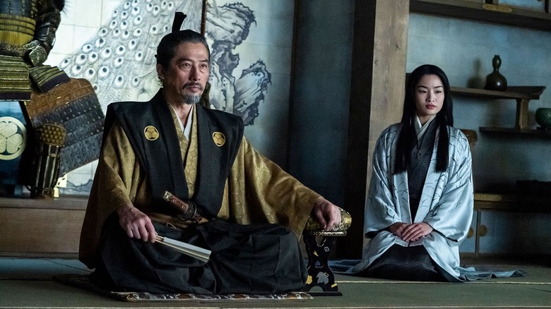Yoshii Toranaga (Hiroyuki Sanada) and Toda Mariko (Anna Sawai) sit by samurai armor on Shōgun