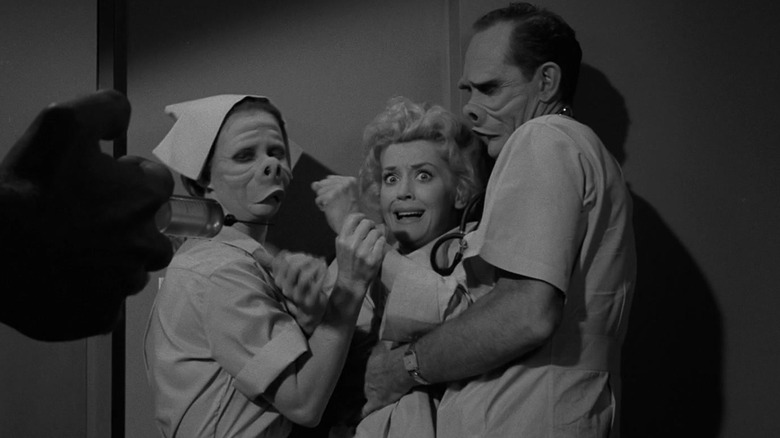 Janet (Donna Douglas) is held back by medical staff (Jennifer Howard and William D. Gordon) who consider her ugly, in The Twilight Zone's Eye of the Beholder