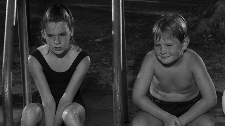 Mary Badham as Sport and Jeffrey Byron as Jeb looking worried in The Twilight Zone episode The Bewitchin' Pool