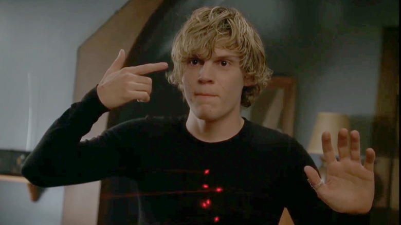 Evan Peters as Tate Langdon points a finger at his head on American Horror Story: Murder House