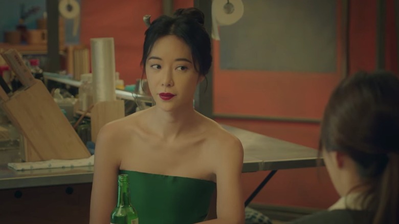 Weol-ju looking at a bar patron at table in Mystic Pop-Up Bar