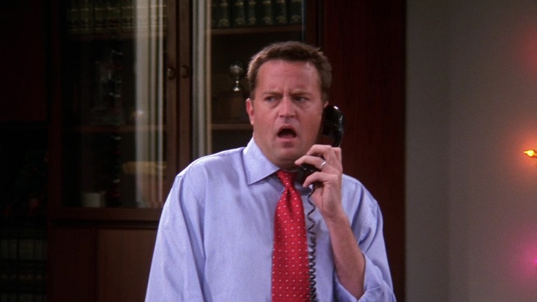 Matthew Perry as Chandler, making a horrified face on the phone on Friends
