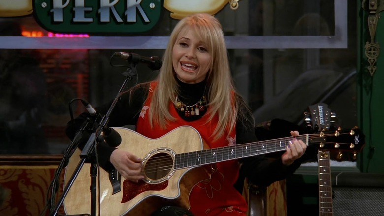 Elizabeth Daily as Leslie, playing guitar on Friends