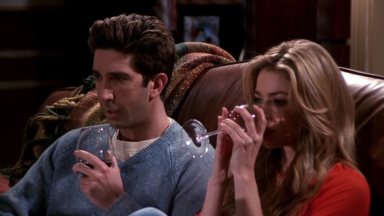 David Schwimmer and Denise Richards as Ross and his cousin, drinking wine together on a couch on Friends