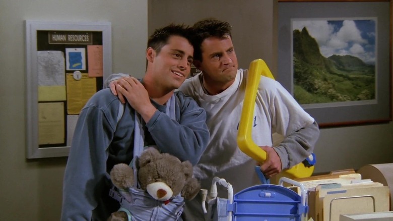 Matt LeBlanc and Matthew Perry as Joey and Chandler, holding hands at a police station on Friends
