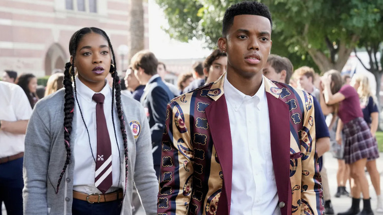 Lisa Wilkes (Simone Joy Jones) and Will Smith (Jabari Banks) stand in front of their school in Bel-Air