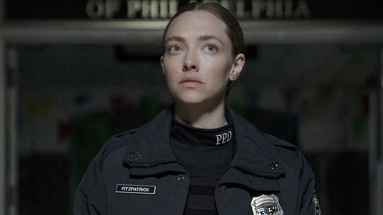 Mickey Fitzpatrick (Amanda Seyfried) stands solemnly in her police uniform in Long Bright River