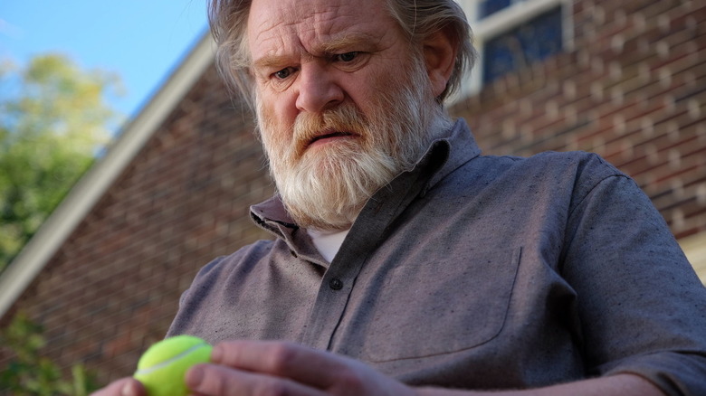 Bill Hodges (Brendan Gleeson) is shocked holding a tennis ball in Mr. Mercedes