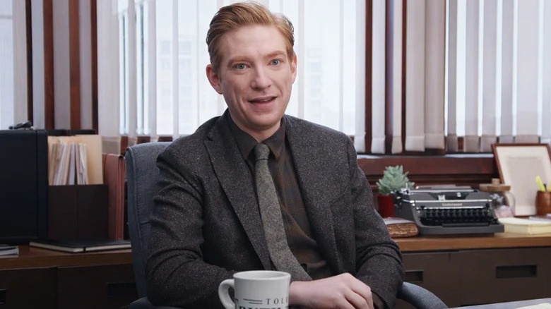 Ned Sampson (Domhnall Gleeson) speaks to the camera at his desk in The Paper