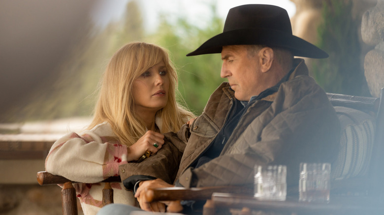 Beth Dutton (Kelly Reilly) speaks to a sullen John Dutton (Kevin Costner) on a porch in Yellowstone