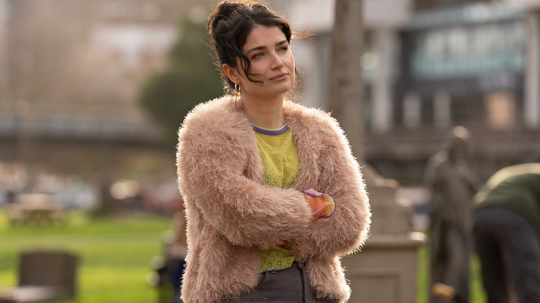 Becka Garvey (Eve Hewson) stands with her arms crossed in a cemetery in Bad Sisters