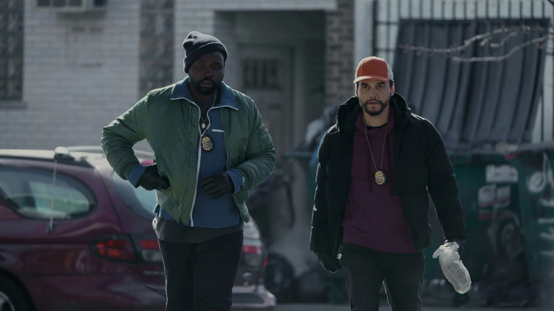 Ray Driscoll (Brian Tyree Henry) and Manny Carvalho (Wagner Moura) walk down a street wearing fake police badges in Dope Thief