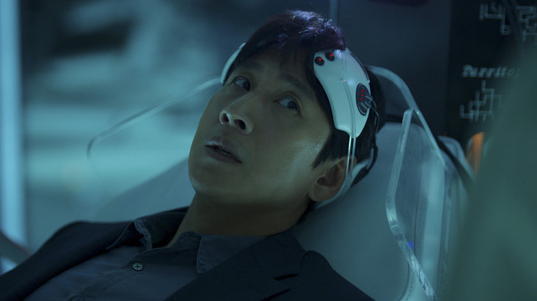 Sewon Koh (Lee Sun-kyun) sits in his neural interface machine on Dr. Brain