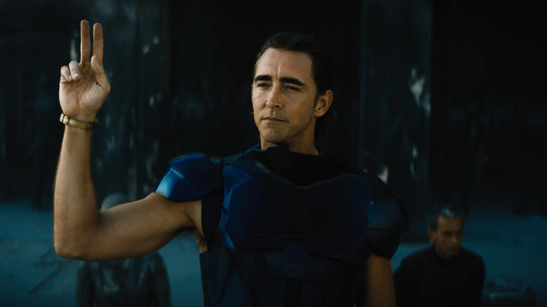 Brother Day (Lee Pace) impassively signals with two raised fingers on Foundation