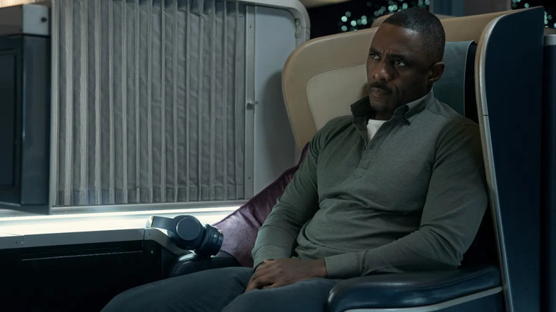 Sam Nelson (Idris Elba) sits sternly in an airplane seat on Hijack