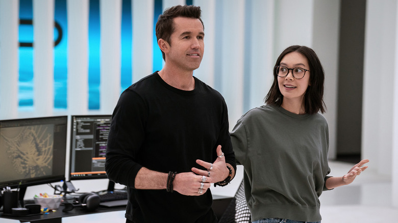 Poppy Li (Charlotte Nicdao) glances at a smug Ian Grimm (Rob McElhenney) on Mythic Quest