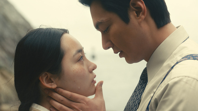 Koh Hansu (Lee Min-ho) prepares to kiss a crying Kim Sunja (Kim Min-ha) on Pachinko
