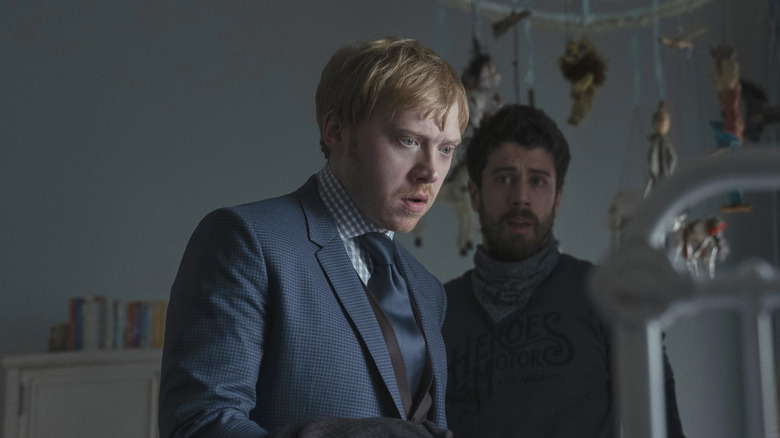 Julian Pearce (Rupert Grint) looks surprised at a crib watched by Sean Turner (Toby Kebbell) on Servant