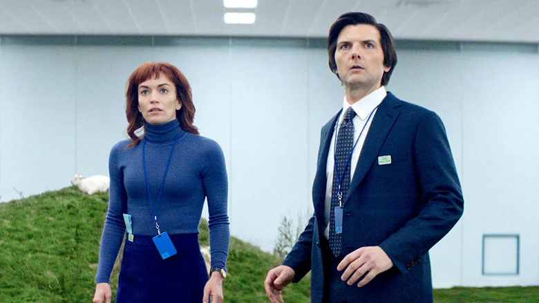 Helly (Britt Lower) and Mark Scout (Adam Scott) stand by a grassy hill in the office in Severance