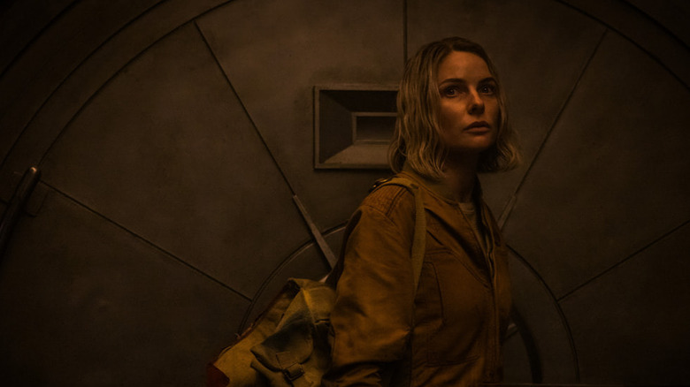 Juliette Nichols (Rebecca Ferguson) stands by a large metal hatch on Silo