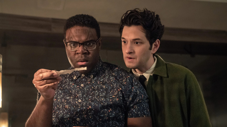 Aniq Adjaye (Sam Richardson) and Yasper E. Lennov (Ben Schwartz) closely examine a scrap of paper on The Afterparty
