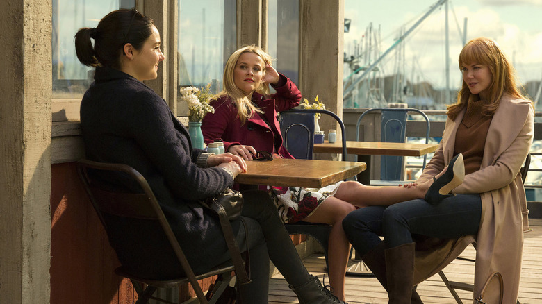 Jane (Shailene Woodley), Madeline (Reese Witherspoon), and Celeste (Nicole Kidman) sitting outside at a coffee shop talking on Big Little Lies