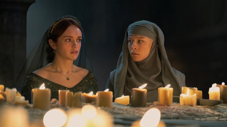 Alicent (Olivia Cooke) and Rhaenyra (Emma D'Arcy) in the sept with candles on House of the Dragon
