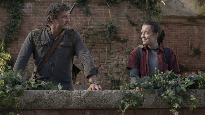 Joel (Pedro Pascal) and Ellie (Bella Ramsey) looking at each other in The Last of Us