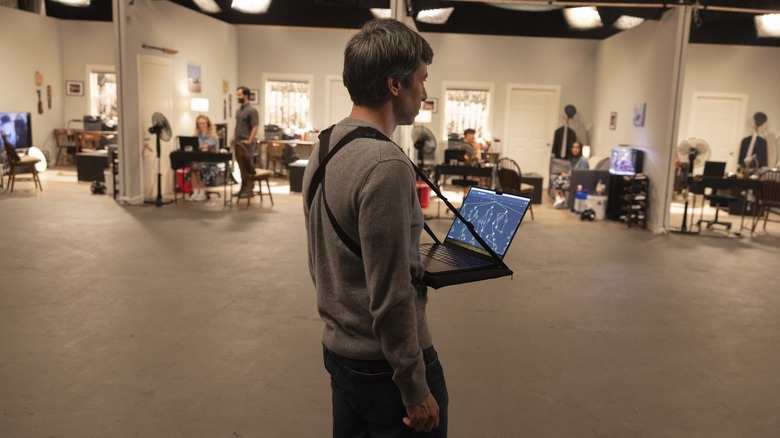 Nathan Fielder with his laptop strapped to his chest observing scenarios in The Rehearsal