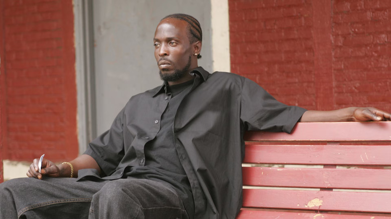 Omar (Michael K. Williams) sitting on a bench staring into the distance on The Wire
