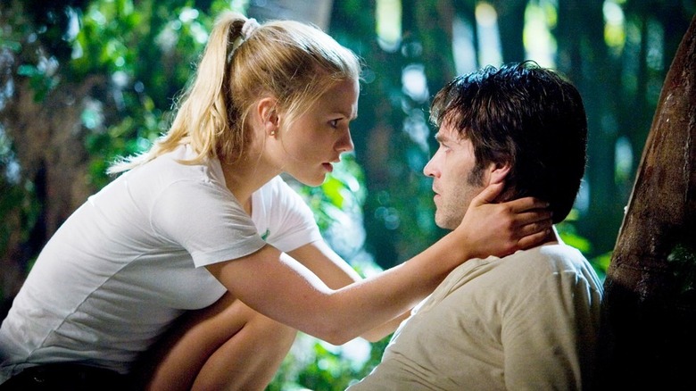 Sookie (Anna Paquin) holding Bill's (Stephen Moyer) head in the woods in True Blood