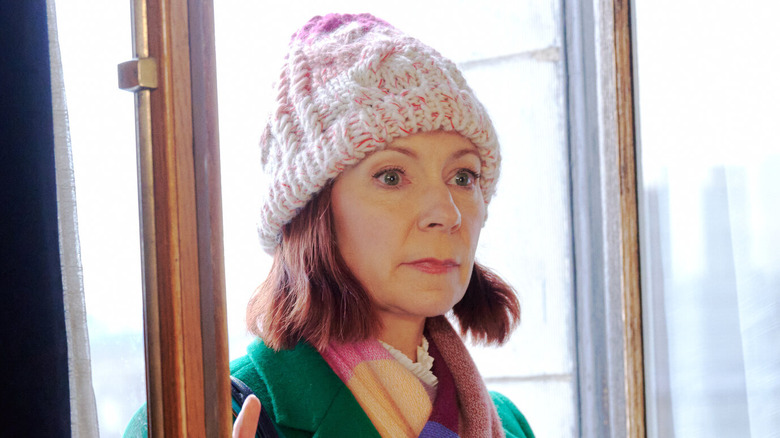 Carrie Preston as Elsbeth Tascioni walks through doors concerned in Elsbeth