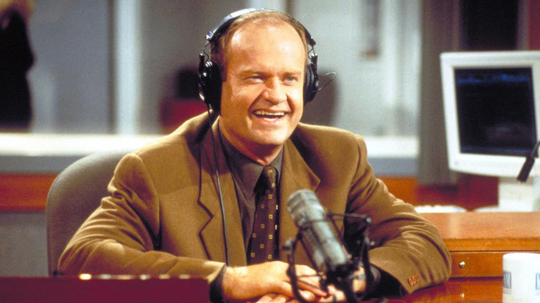 Kelsey Grammer as Frasier Crane, laughing into a microphone on Frasier