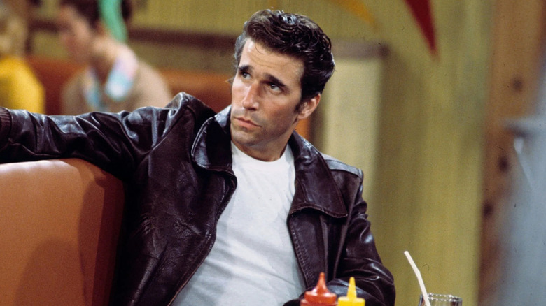 Henry Winkler as Arthur "Fonzie" Fonzarelli, leaning back in a diner booth on Happy Days