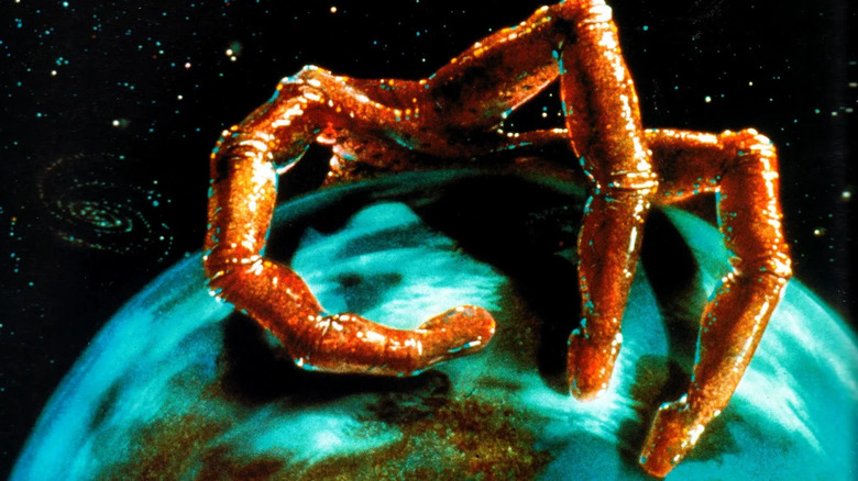 Promotional art for the 1988 television series, War of the Worlds, showing a three-fingered alien hand looming over the Earth.