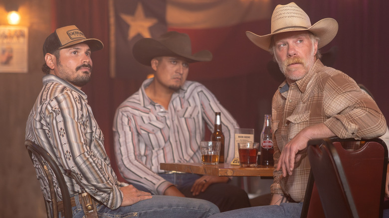 Azul, and Zachariah sitting at a table with drinks on it in Dutton Ranch
