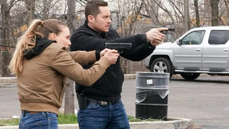 Tracy Spiridakos as Hailey Upton and Jesse Lee Soffer as Jay Halstead aiming their weapons on Chicago P.D.