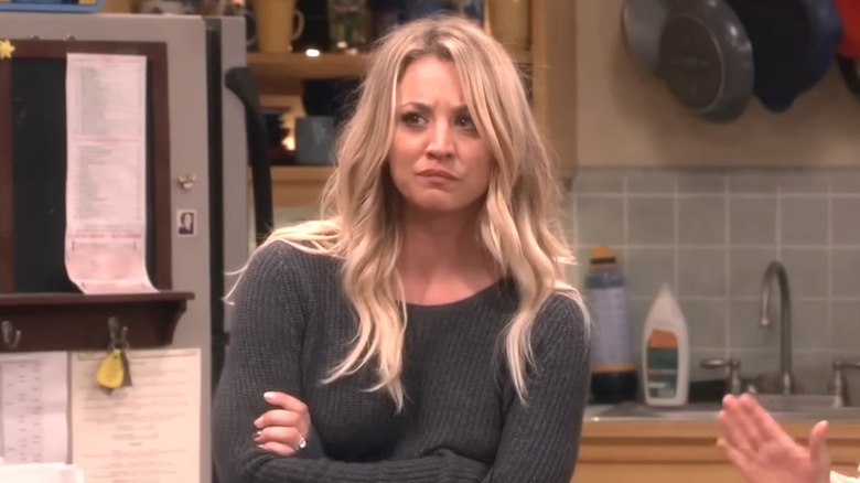 Penny wearing a grey sweater in the boys' apartment in "The Big Bang Theory."